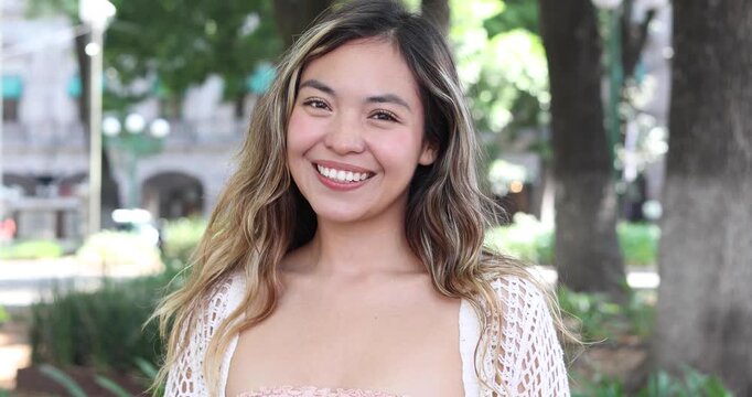 portrait of young latin woman in public park in Mexico Latin America