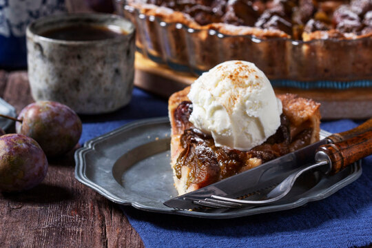 German plum cake with cinnamon, served with ice cream and coffee.