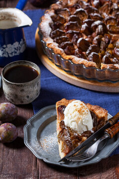 German plum cake with cinnamon, served with ice cream and coffee.