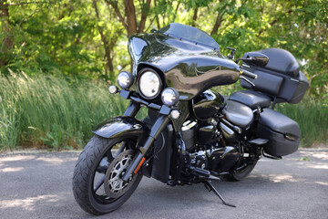 Fototapeta premium Modern black motorcycle parked on road outdoors