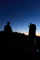 Amateur astronomer observing stars, planets, Moon and other celestial objects with a telescope in nature. © astrosystem