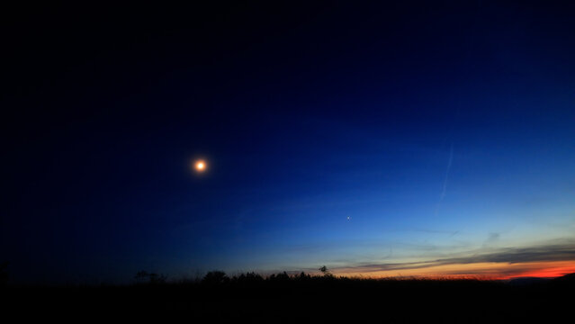 Moon, planet conjunction and landscape scenery silhouettes.