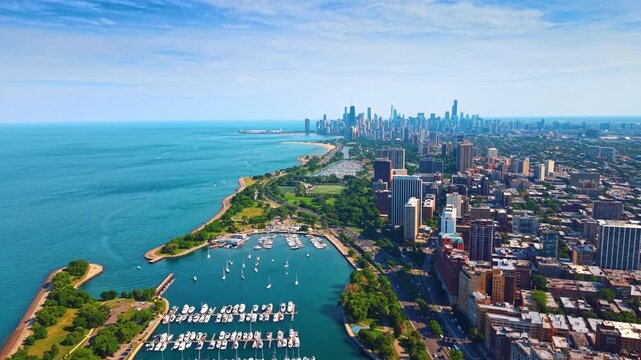 Breath-taking scenery of lake Michigan shoreline with lively traffic and harbor with numerous vessels. Drone footage over Chicago, Illinois, USA.