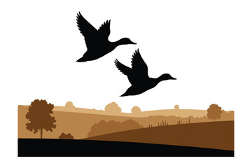Naklejka premium Flying wild ducks silhouette over scenic countryside field landscape with wildlife
