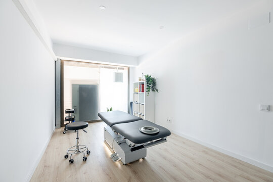 Physiotherapy clinic interior with massage table