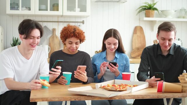 Home party. Friends holding smartphones touch screen typing scroll page in kitchen at home. People with cell phones surfing internet using social media apps on party. Internet news cellphone addiction