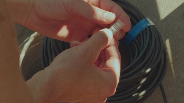 Working with wires, internet wire, installing an internet patch cord, hands working with wires