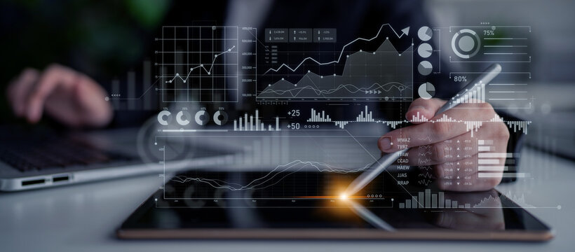 Business analyst engages with digital graphs and data visualizations on a tablet, reflecting modern analysis techniques in a professional setting. Scalp