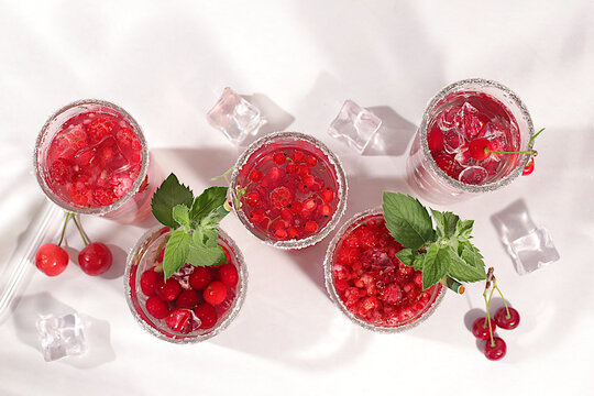 Dietary vegan water with raspberries, currants, and cherries, detox water, mojito with Sprite, mint, and fresh berries. Detox diet and weight loss concept, healthy lifestyle advertising,