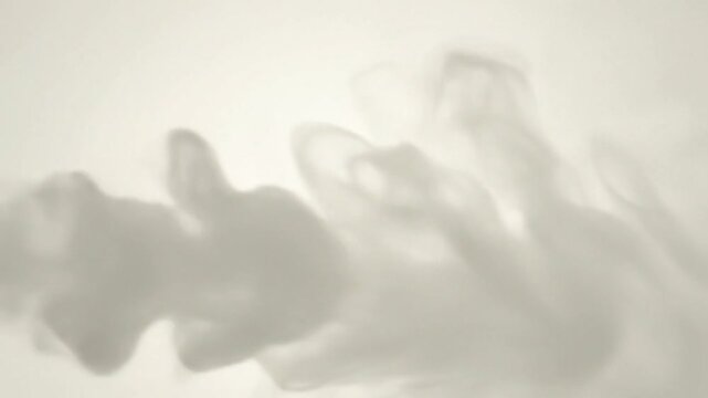 Abstract slow motion footage of swirling smoke against a light, neutral background, for creative use