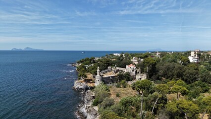 Fototapeta premium Aerial view of Castello Filangieri historic fortress with tower on Capo Oncino promontory overlooking Gulf of Naples, Torre Annunziata, Italy