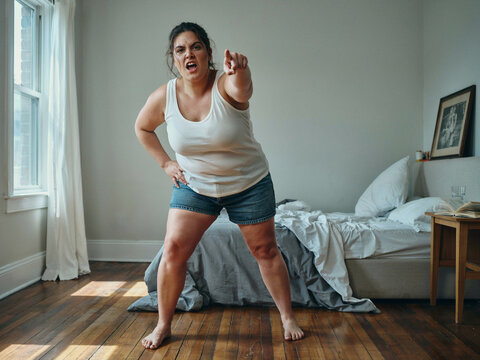 angry woman yelling and pointing at viewer