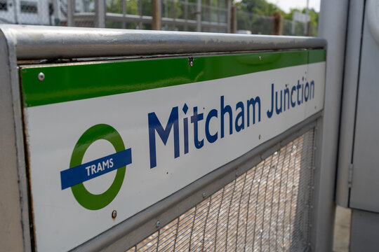 Mitcham Junction Tram Station Sign Close-Up with Fence in Background