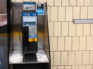 Obraz premium Bell payphone with crisis link information mounted on metal stand on transit subway station, Toronto Canada July 2026