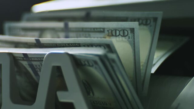 Close-Up of US 100 Dollar Bills Moving Through Money Counting Machine, Cash Counting Process, Banking Finance, Currency Verification, Wealth, Business Investment, Financial Transaction Concept