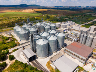 Large storage facility with silos and agricultural land viewed from above during daylight hours © DSMT