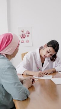 Oncologist doctor prescribing medication to cancer patient