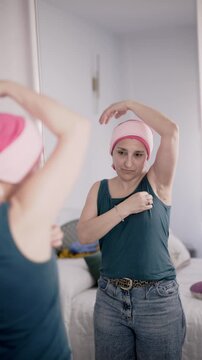 Cancer survivor woman examining her mastectomy scars in the mirror