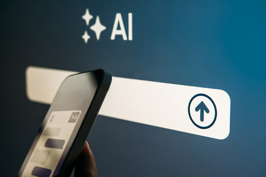 Young woman writing AI promt in a modern office.