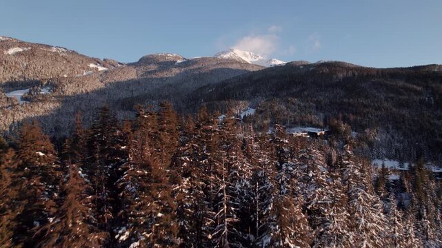 Alpine homes on hill at sunset, Whistler Mountain, aerial footage, winter scene, log cabin, luxury vacation home, mountain home. 4K 24FPS