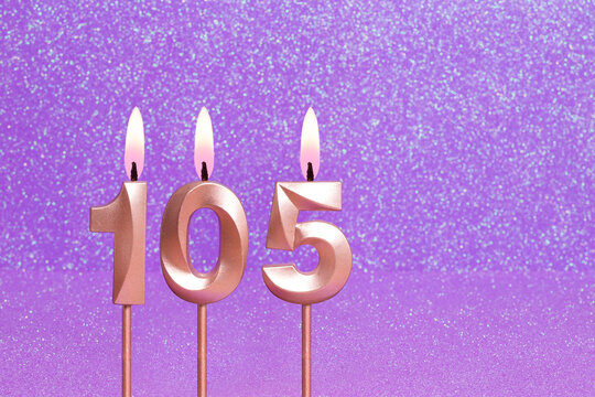 Number 105 on a pink background with blurred bright dots