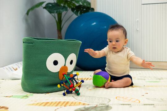 Baby exploring colorful toys during early childhood development playtime