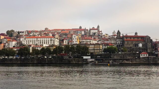 Historical city of porto in portugal seen from the douro river on an overcast day, showcasing the beautiful traditional architecture of the ribeira district, a popular european travel destination