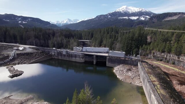 Aerial drone view of hydroelectric dam and reservoir in Whistler, British Columbia, Canada. PRORES