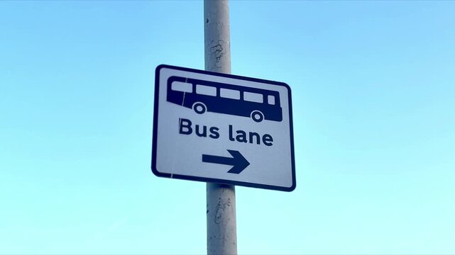 public transport warning bus lane road sign on pole with blue sky background