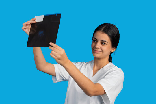 Young medical professional examining x-ray image for diagnosis