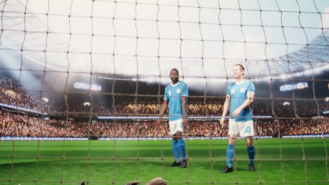 Blurred motion of footballer hitting ball and net in front of goalkeeper, player in motion attacking to score goal, goalie defending and blocking goal post by striker, attack action.