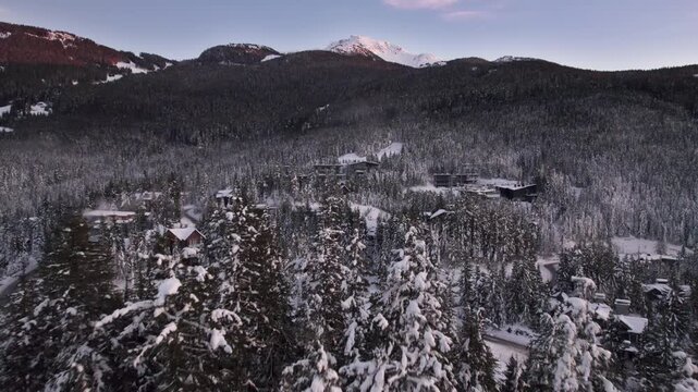 Alpine homes on hill at sunset, Whistler Mountain, aerial footage, winter scene, log cabin, luxury vacation home, mountain home. 4K 24FPS