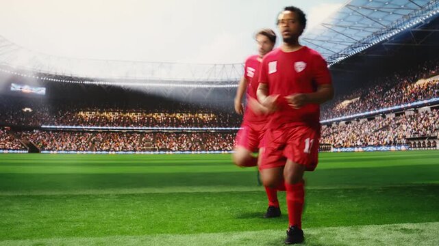 Footballer running forward with soccer ball in possession, breaking away from defender with agility and pace, low angle action showing intense football attack.