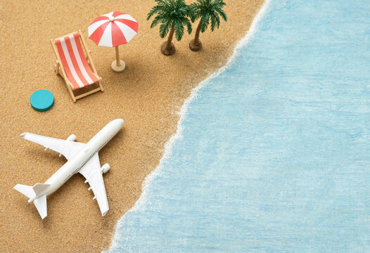 Miniature Tropical Beach Scene with Airplane, Palm Trees, and Umbrella Representing Vacation, Relaxation, and Travel Concept Illustration