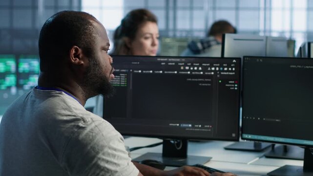 Admin in server hub assigned to protecting valuable data against hacking attacks while capturing firewall review, server bottlenecks and technical problem solving.