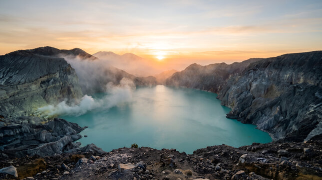 Scenic sunrise view of Kawah Ijen crater lake with volcanic landscape. Suitable for tourism campaigns, environmental education, and travel publishing.