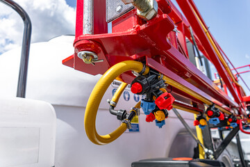 Agricultural field sprayer nozzle body on boom for pesticide application. Modern crop protection machinery engineering component and farming transport equipment closeup details for cultivation. © NastyaPhoto