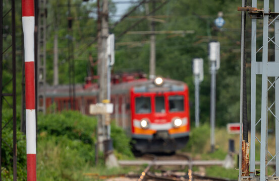 a red train emerging from around a bend
