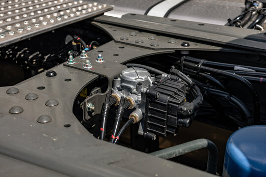 Semi truck chassis EBS brake control valve valve module. Modern commercial heavy duty transport vehicle air pneumatic system component on frame with long haul tractor technical engineering details.
