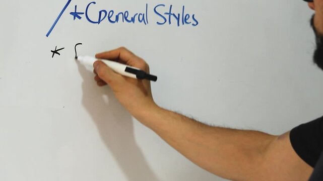 Detailed view of a developer writing a CCS Code on an acrylic whiteboard