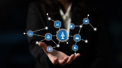 A businessman presents a hand-held network of digital icons, symbolizing technology and innovation. This image conveys connectivity and growth in modern business practices. Tessel © InfiniteFlow