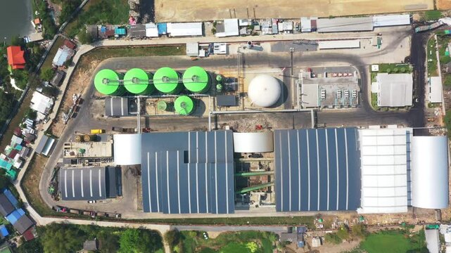 Aerial view showcases advanced industrial wastewater treatment plant incorporating solar panels and large tanks utilizing RDF (Refuse Derived Fuel) technology within modern facility, highlighting sust