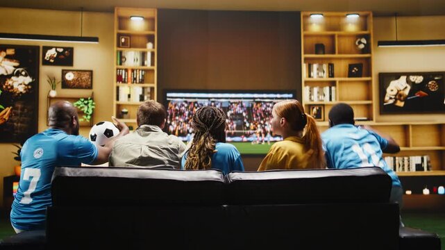 Upset football supporters curse players after a close scoring chance while soccer fans show annoyed body language during the match.