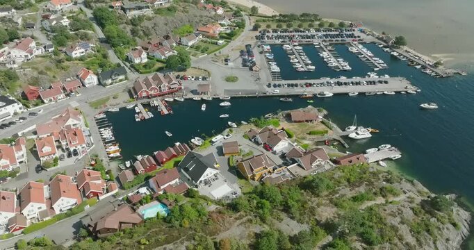 Aerial view of coastal marina and residential area in H&oslash;llen Norway in slow motion