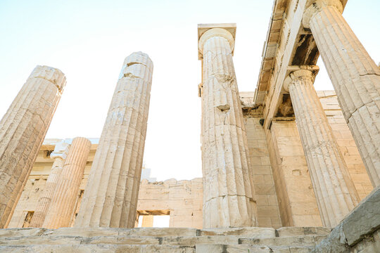 Low angle view of the ancient marble columns of the Propylaea at the Acropolis in Athens, Greece.
