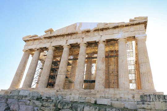 Low angle view of the Parthenon temple and restoration work on the Acropolis in Athens, Greece.