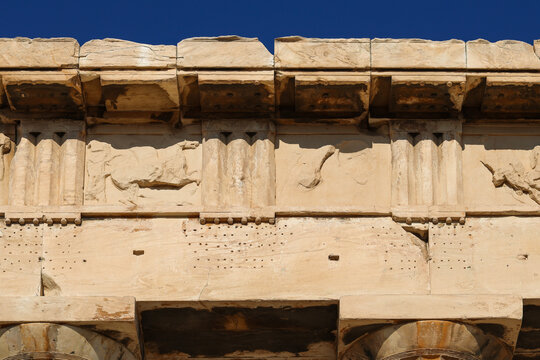 Close-up of weathered stone carvings and architectural details of the Parthenon on the Acropolis in Athens, Greece.