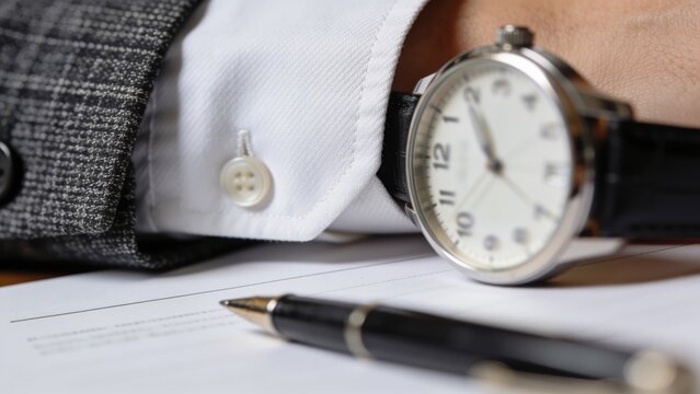 Businessman Checking Watch Near Contract and Pen, Time Management Concept