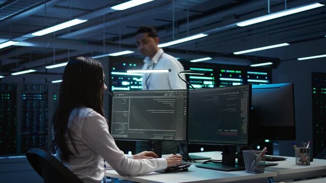 Cybersecurity team monitors cybersecurity risks inside a data center setting, using network security, data protection and regulatory compliance through careful enterprise system oversight