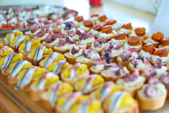 Assorted Mediterranean canap&eacute;s and gourmet appetizers displayed on a serving platter at a catered event.